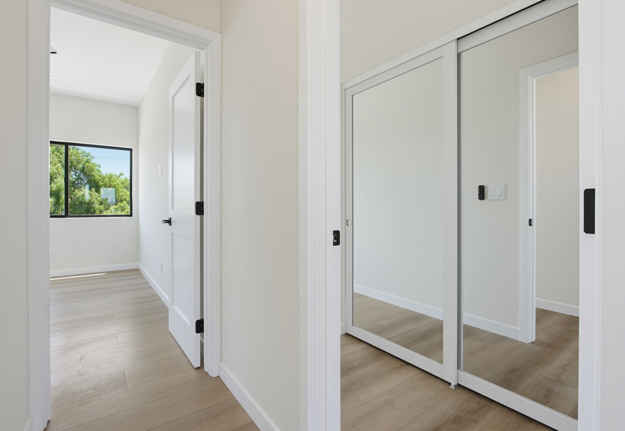 Two-story ADU hallway with bedroom and mirrored closet doors, San Diego
