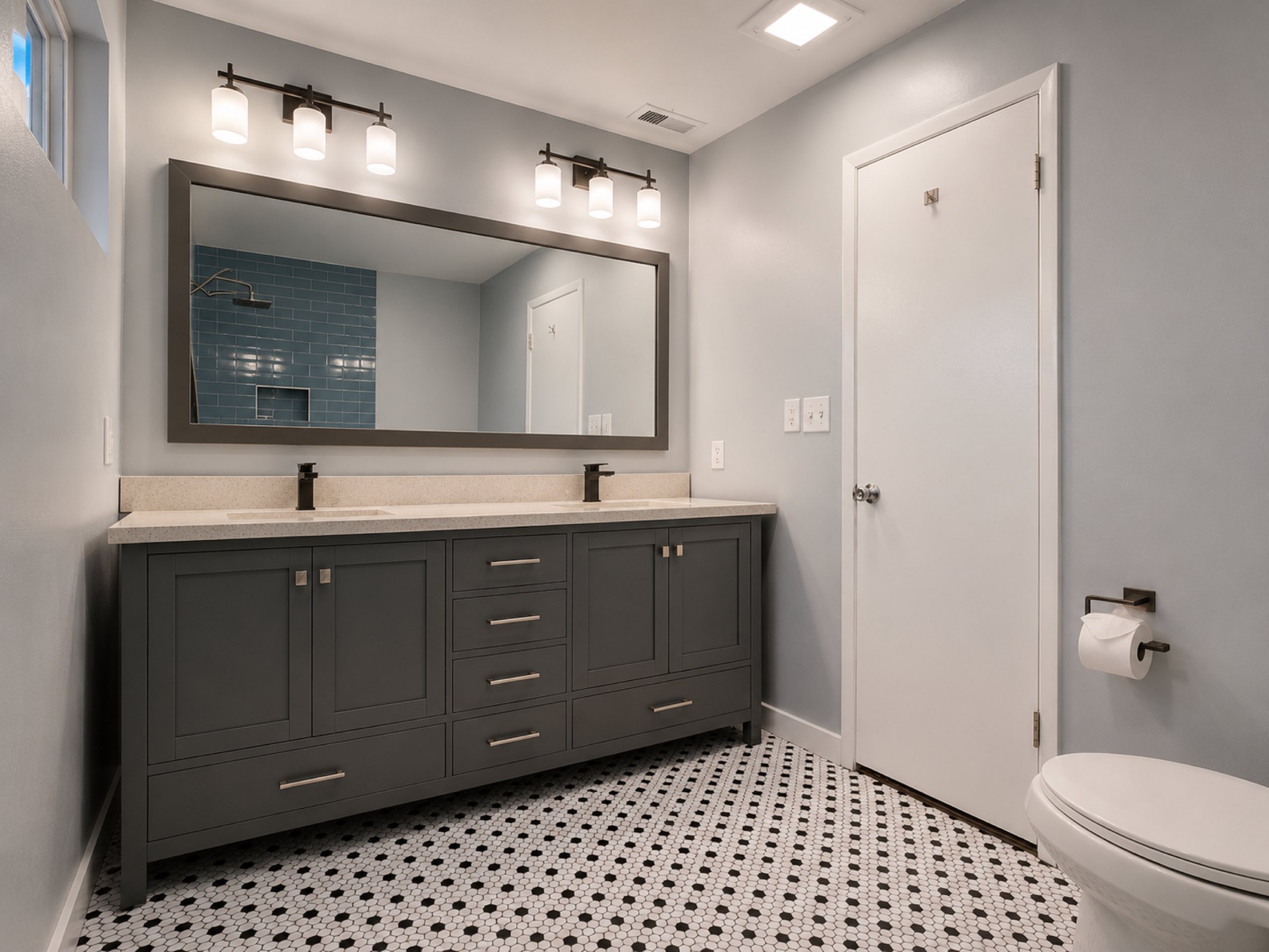 Bathroom double vanity with blue accent tile shower San Diego - Complete Builders Inc
