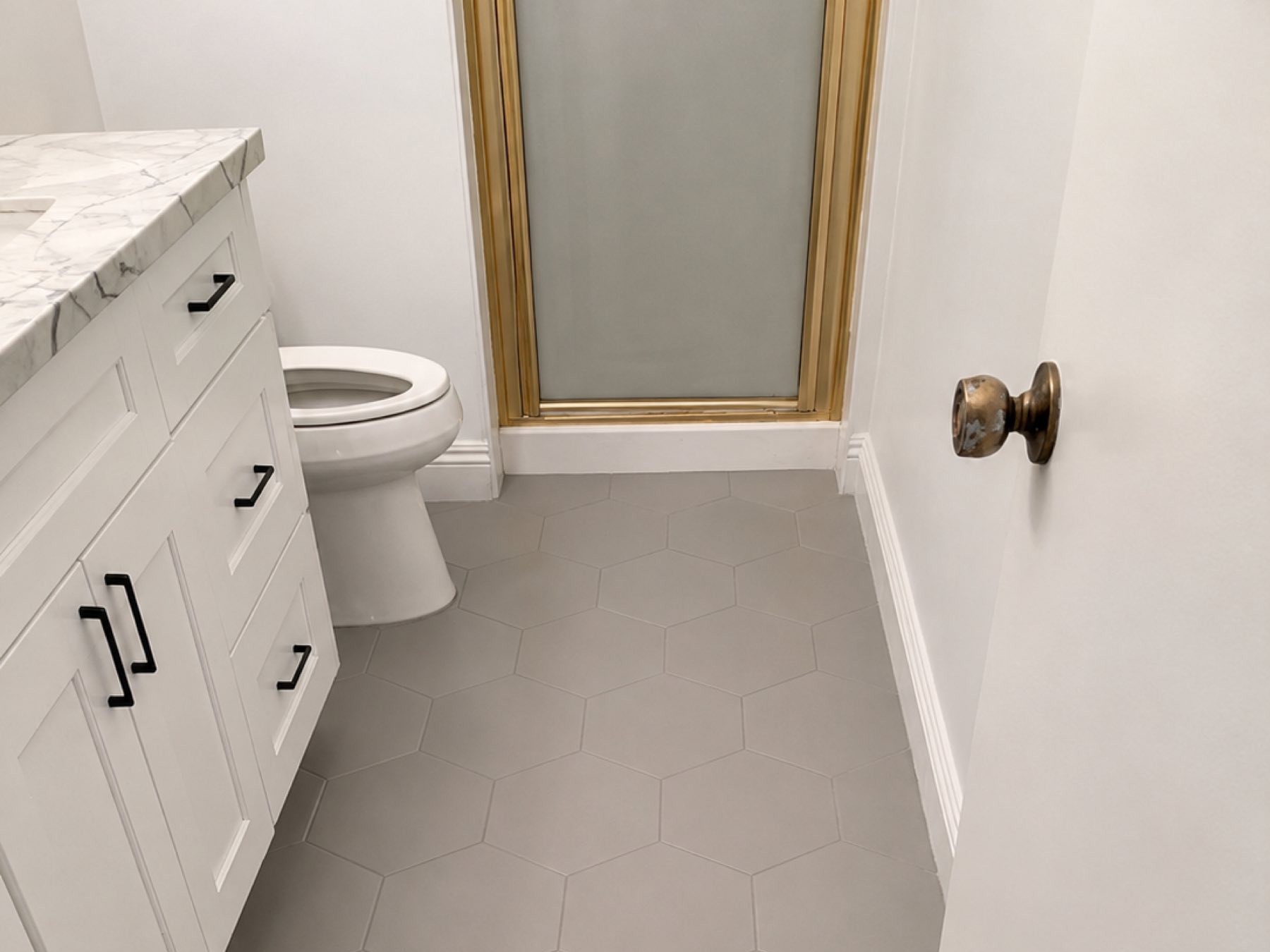 Large format hex tile floor white marble vanity San Diego - Complete Builders Inc