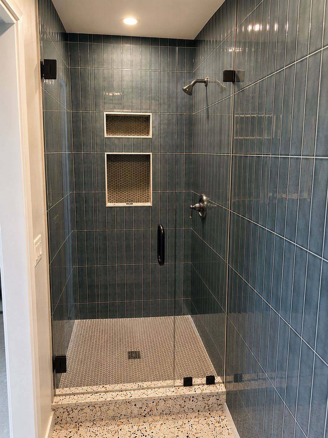Remodeled walk-in shower with linear tile and double niche, San Diego