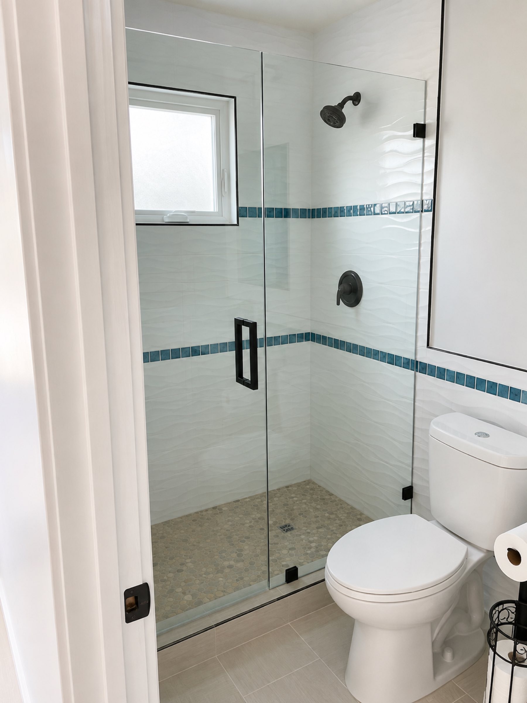 Bathroom shower with teal accent tile band San Diego - Complete Builders Inc