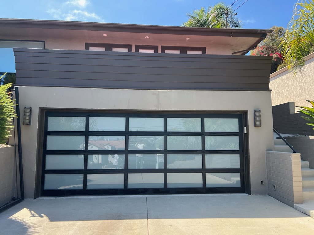 Modern glass garage door exterior remodel San Diego - Complete Builders Inc