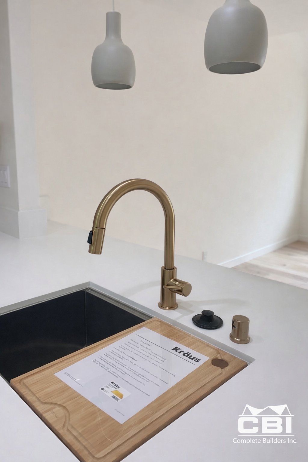 Kitchen detail gold faucet black workstation sink quartz San Diego - Complete Builders Inc