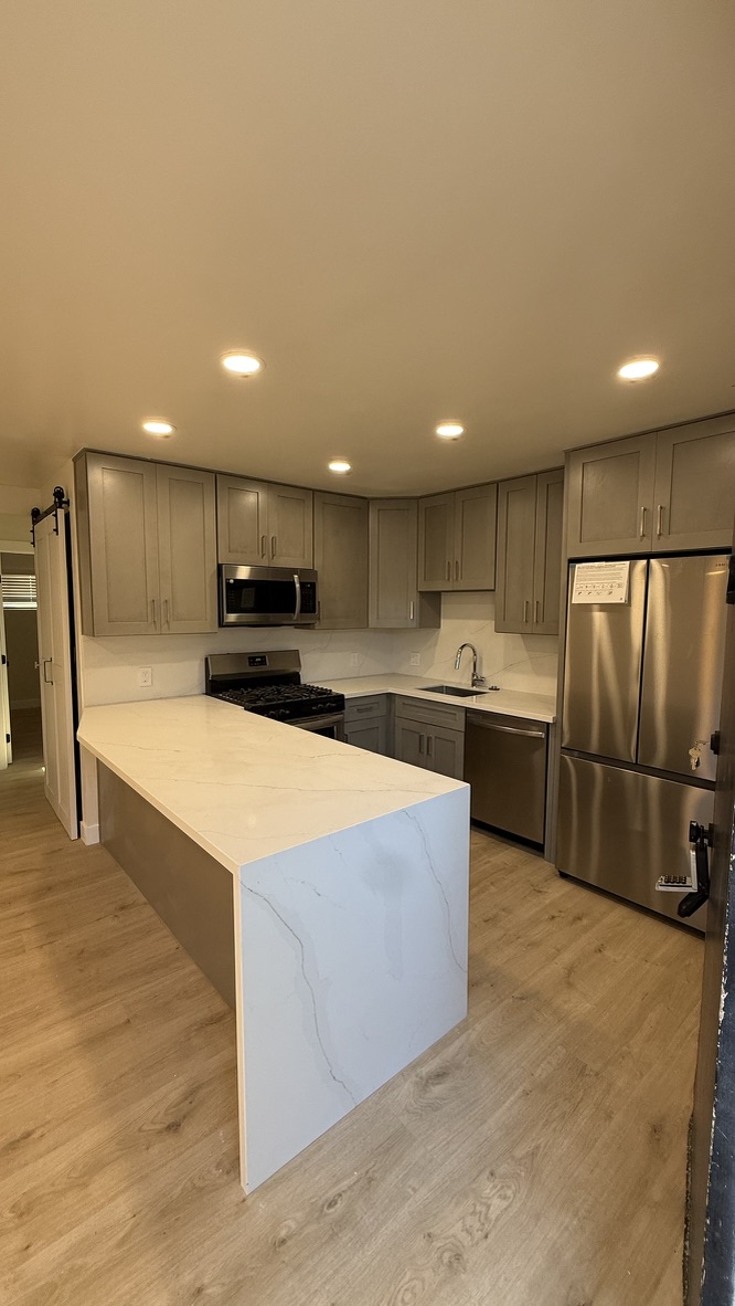 Kitchen remodel gray shaker cabinets quartz island San Diego - Complete Builders Inc