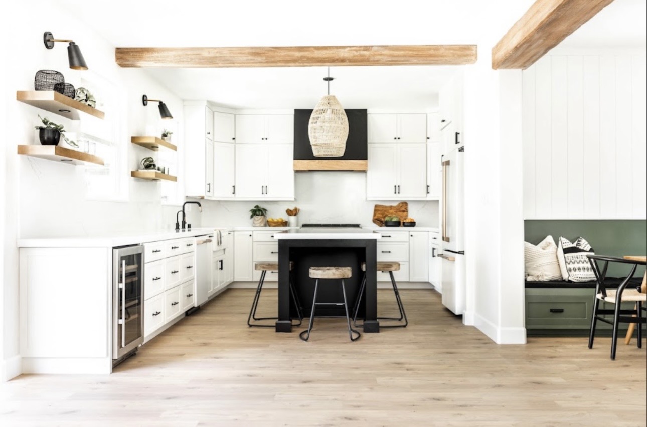 Kitchen remodel white cabinets exposed beams black island San Diego - Complete Builders Inc