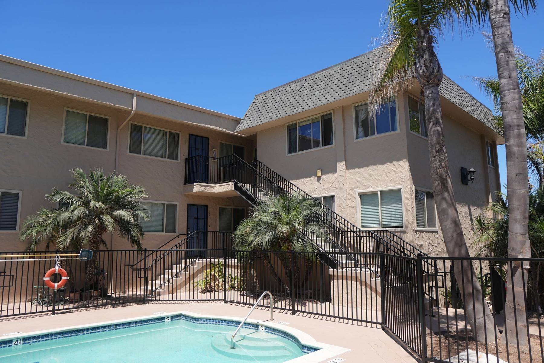 Multifamily apartment property pool and exterior stairs, San Diego