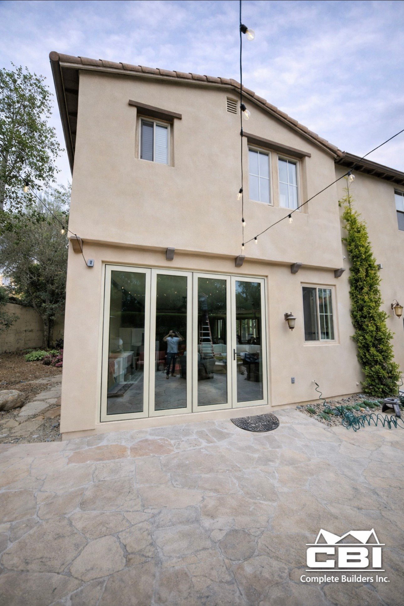 Room addition with bifold doors closed flagstone patio San Diego - Complete Builders Inc