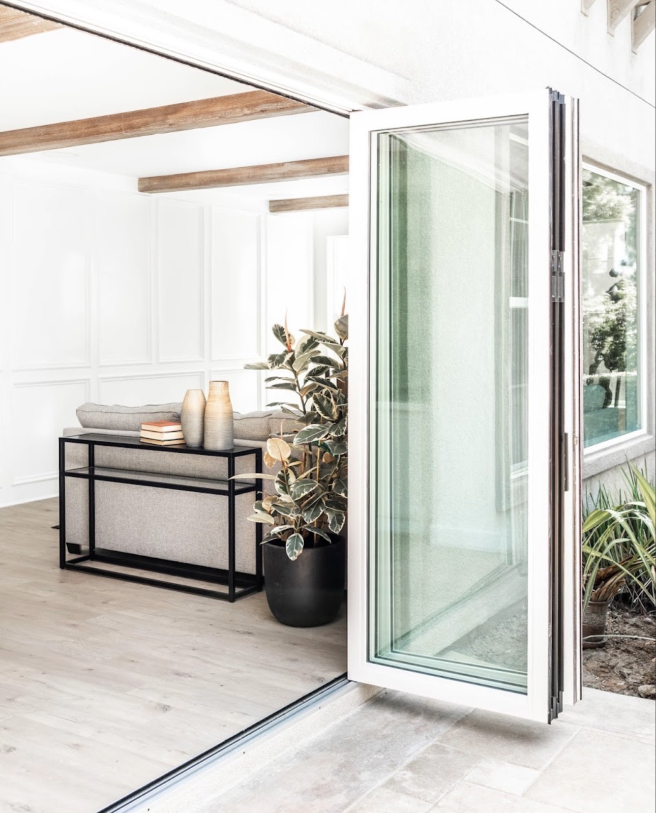 Room addition bright interior bifold doors exposed beams San Diego - Complete Builders Inc