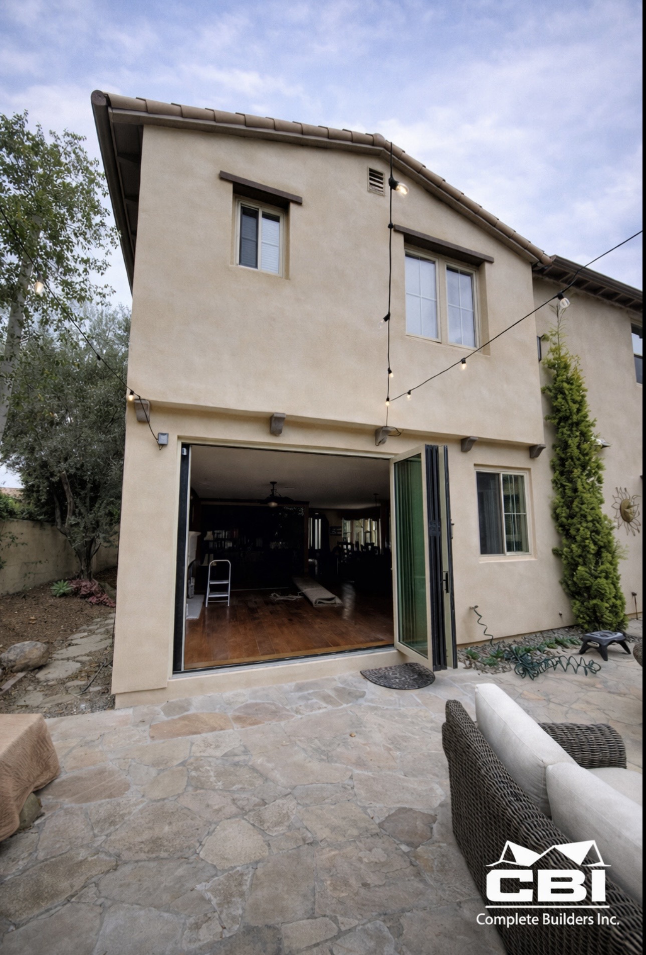 Room addition with bifold doors fully open to patio San Diego - Complete Builders Inc