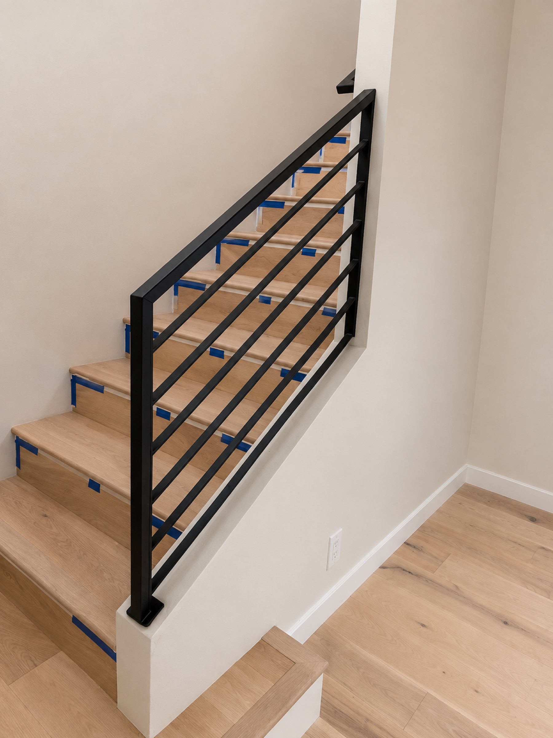 Interior staircase railing installation in progress San Diego - Complete Builders Inc